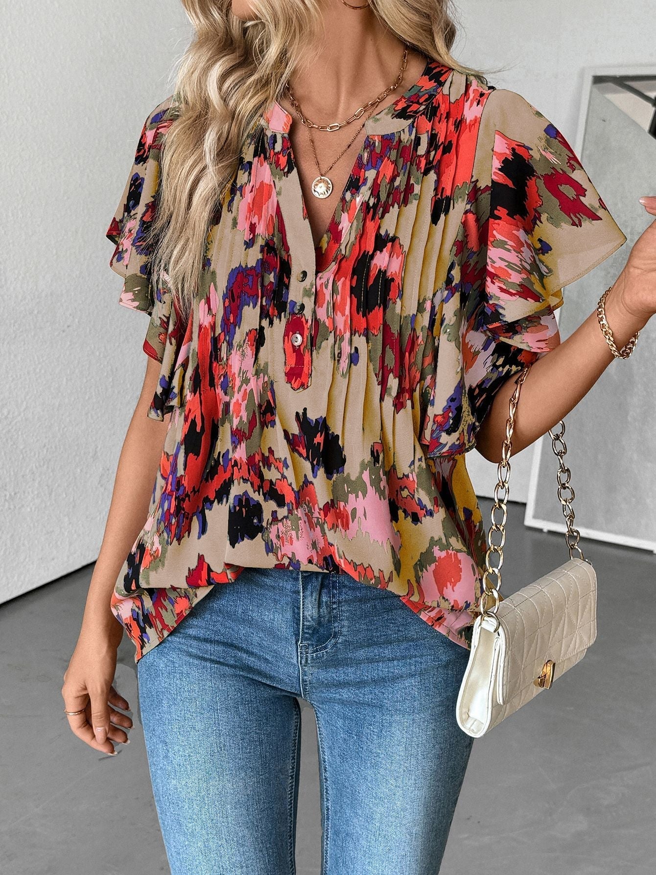 Women's blouse with elegant ruffle details and playful print, size S