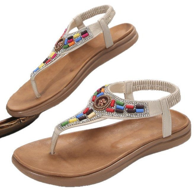 Women's thong sandals with colorful decorative detail and comfortable footbed design, size GR