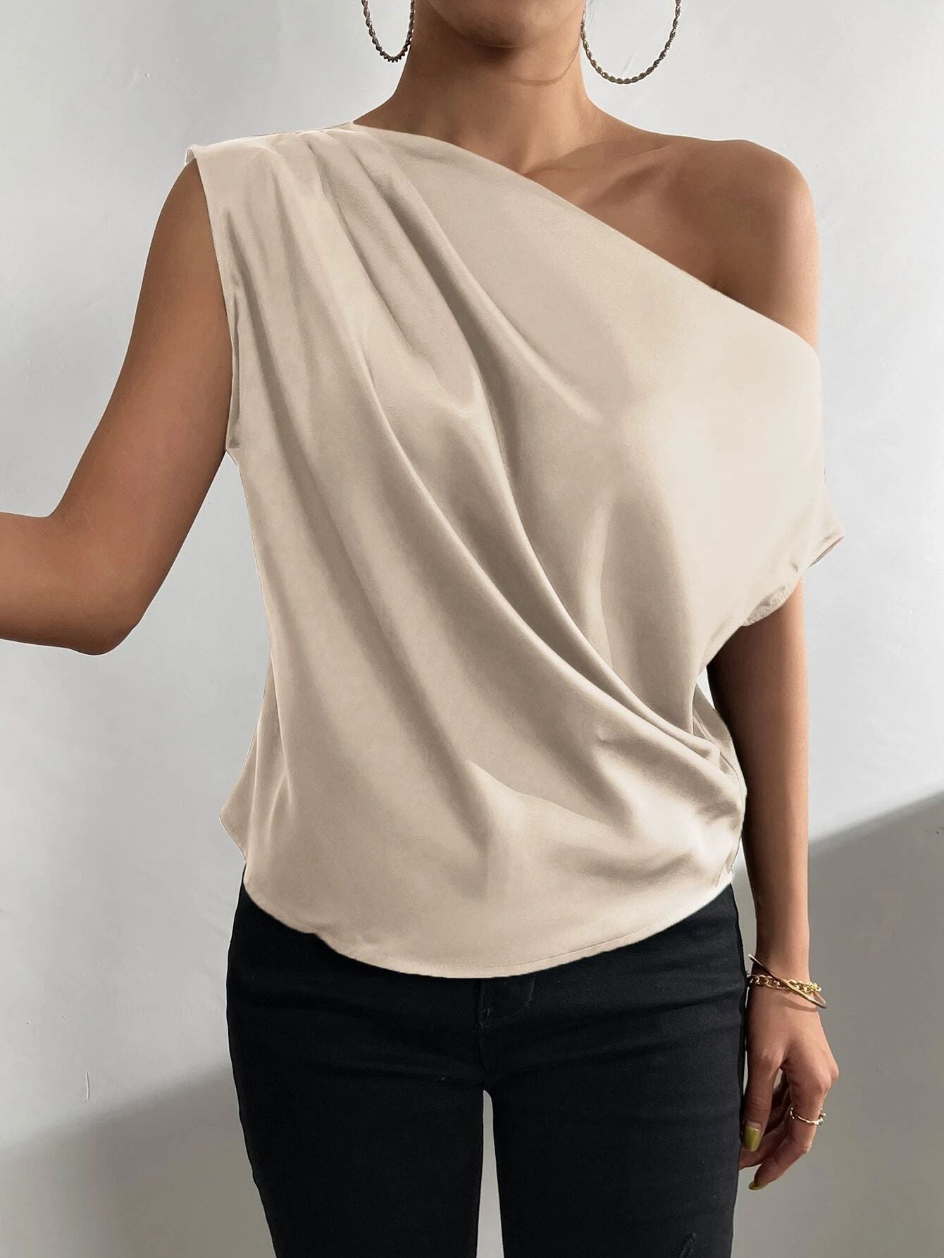 Women's asymmetrical top with draping and elegant cut, size
