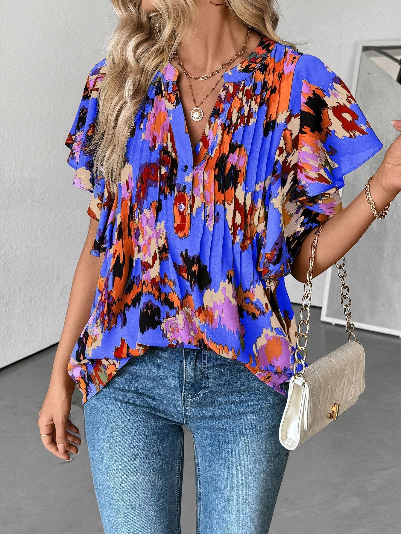 Women's blouse with elegant ruffle details and playful print, size S