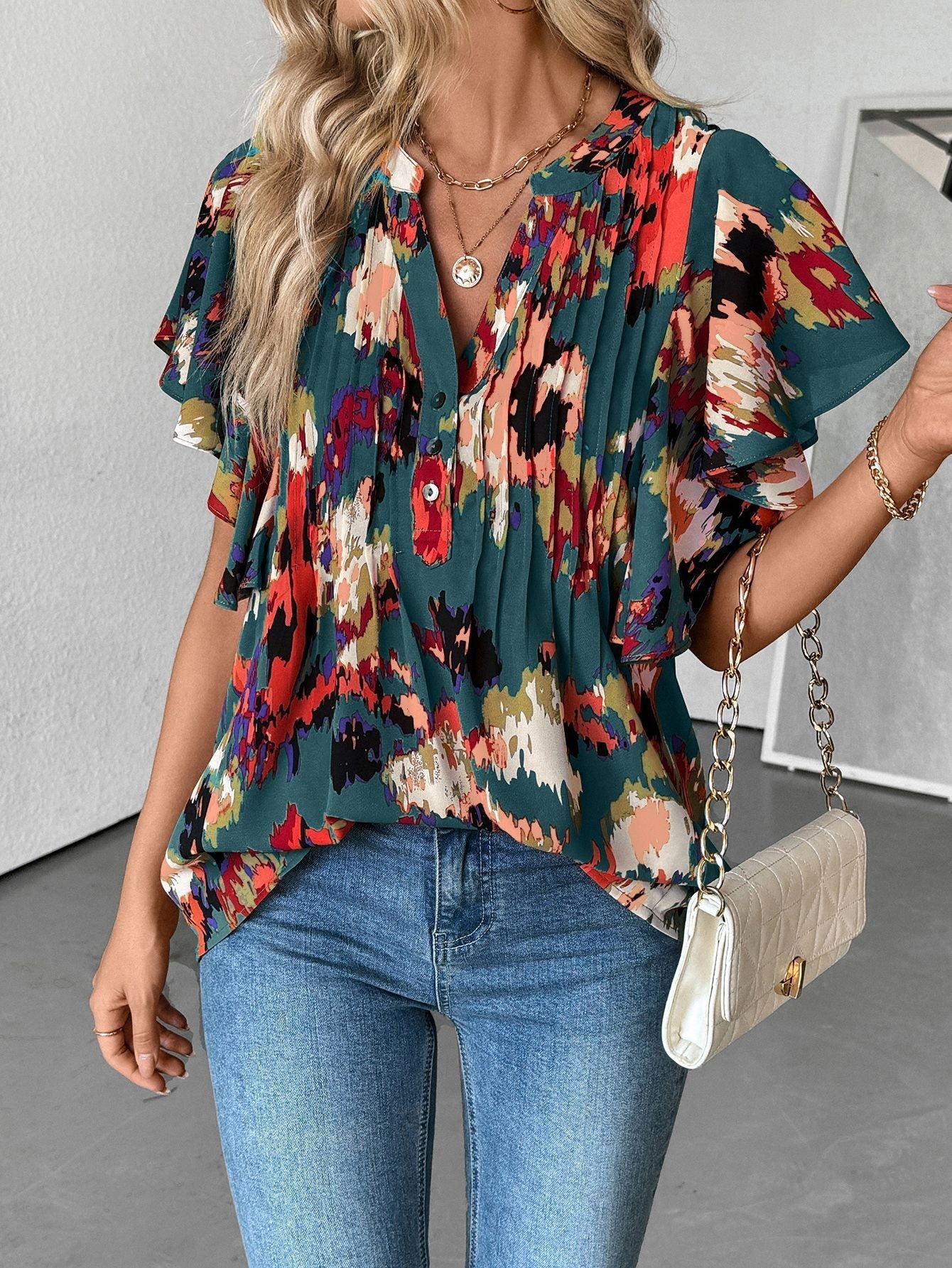 Women's blouse with elegant ruffle details and playful print, size S