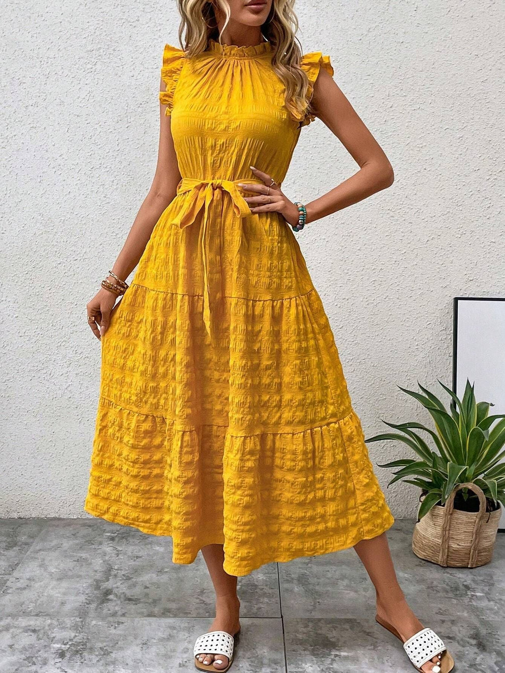 Women's wrap dress with ruffle details and a tailored hem, size