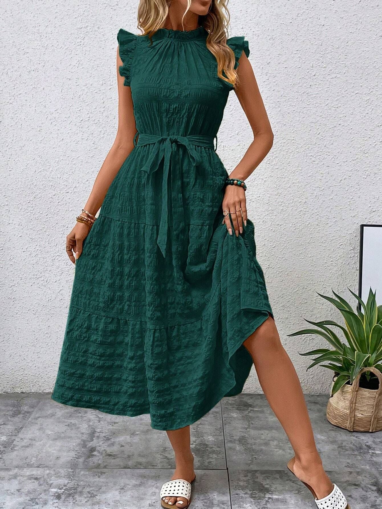 Women's wrap dress with ruffle details and a tailored hem, size