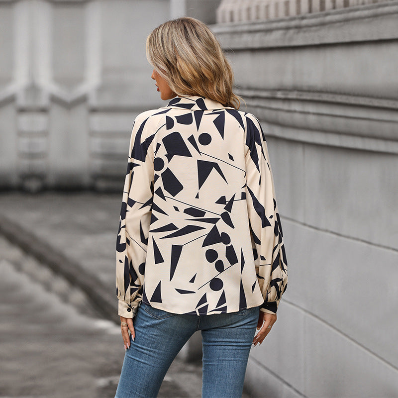 Women's blouse with a striking graphic design and voluminous sleeves, size S