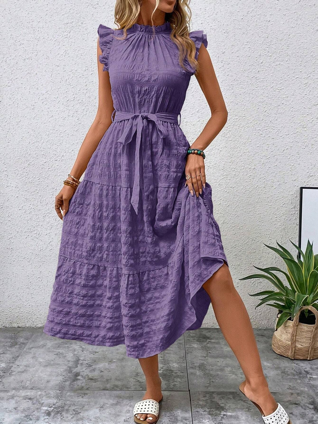 Women's wrap dress with ruffle details and a tailored hem, size