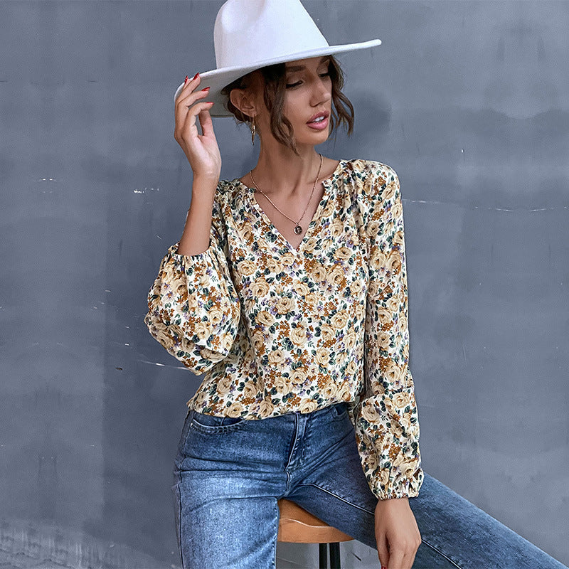 Women's blouse with floral design and elegant puff sleeves, size