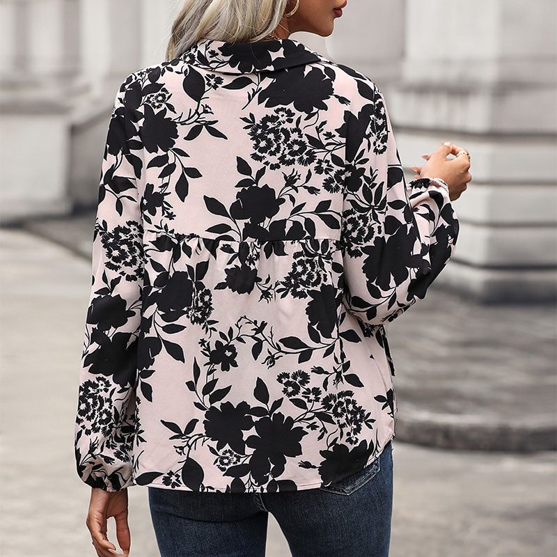 Women's blouse with elegant ruffle details and playful floral pattern, size
