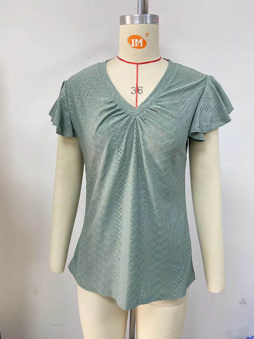 Women's blouse with short, structured sleeves and sophisticated openwork patterns, size S