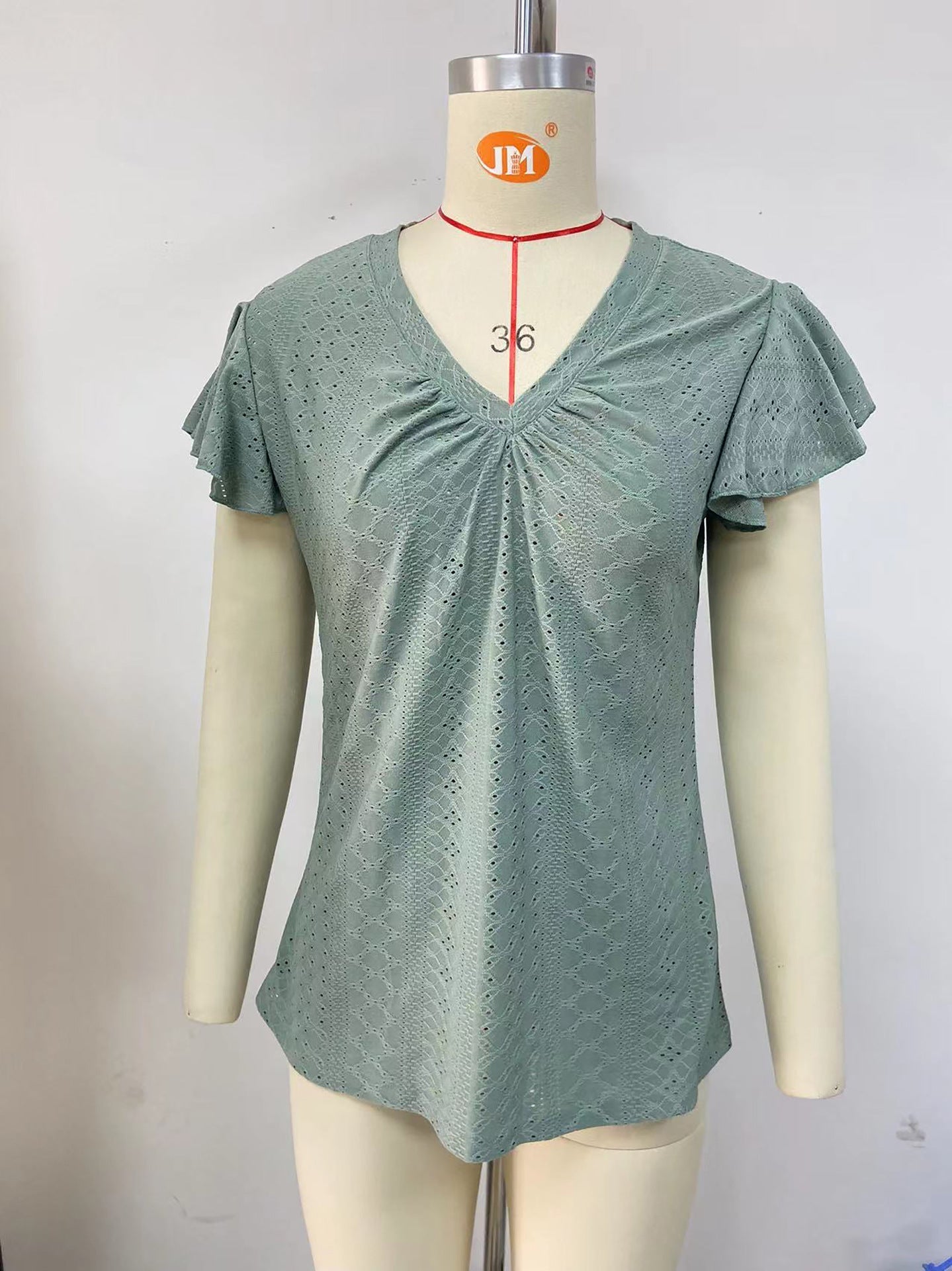 Women's blouse with short, structured sleeves and sophisticated openwork patterns, size S